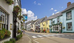 Main street and historic buildings - shops and pub, in the British village of Modbury in Devon, England.