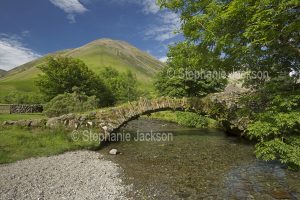 Ancient pack horse bridge crossing Mosedale Beck at Wasdale Head in the English Lake District.