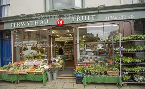 Fruit and vegetable / greengrocer's shop with signs in the Welsh language, in the town of Criccieth in Wales.