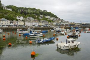 Waterfront houses and the harbour at the coastal town of Looe in Cornwall, England.