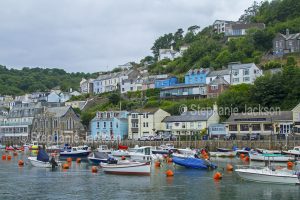 Harbour and colourful hillside houses in the British coastal town of Looe in Cornwall, England.