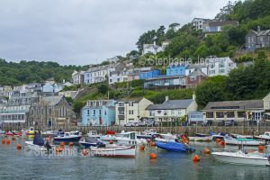 Waterfront houses and the harbour at the coastal town of Looe in Cornwall, England.