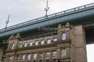 The historic Tyne Bridge above the roofs of buildings in the British city of Newcastle-upon Tyne / Newcastle in Northumberland, England.