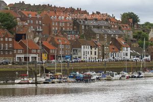 Waterfront houses and harbour at Whitby in Yorkshire, England.