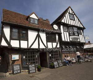 Mediaeval building, now a cafe, with people dining outside, in the historic city of York in Yorkshire, England.