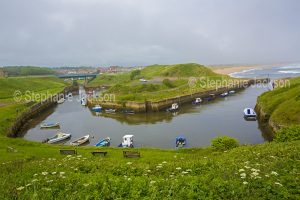 Boats moored in the sheltered harbour at Seaton's Sluice in Northumberland, England