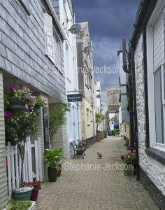Narrow street and houses in the coastal town of Looe in Cornwall, England.