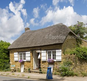 Historic British buildings, houses, Thatched stone cottage in the village of Abbotsbury, in the Jurassic Coast region of Dorset, England.
