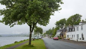 Waterfront cottages / houses beside Loch Carron in the village of Lochcarron in Scotland on a misty morning