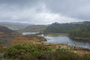 Misty morning over landscape and loch in the Scottish highlands, near Achmelvich.