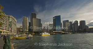 Skyscrapers of city of Sydney rising beside waters of Circular Quay and Sydney harbour, in NSW Australia