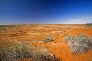 Arid and desolate outback landscape and red sand dunes on route north of Innamincka in South Australia.