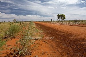 Red outback road, the Sandover Highway, in the Northern Territory, Australia
