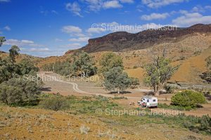 Campers in arid landscape at Mount Chambers Gorge in the Flinders Ranges region of northern / outback South Australia.