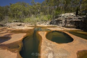 Unusual geological formations, rock pools and water in Mimosa Creek at Blackdown Tablelands National Park in Queensland Australia