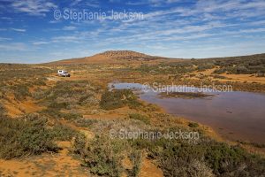 Wilochra Creek in the Flinders Rangers region north of Quorn in outback South Australia, with campervan on dirt track.