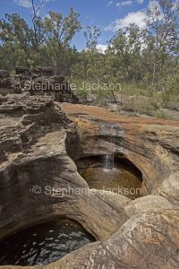 Unusual geological formations, rock pools with water in Mimosa Creek at Blackdown Tablelands National Park in Queensland Australia